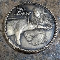 Coin engraved with a young woman feeding a calf, with the word Love and a rope border