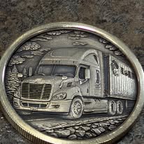Coin engraved with a semi truck and trailer