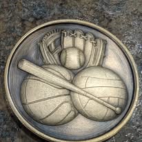 Coin engraved with a baseball glove, bat, basketball, and volleyball